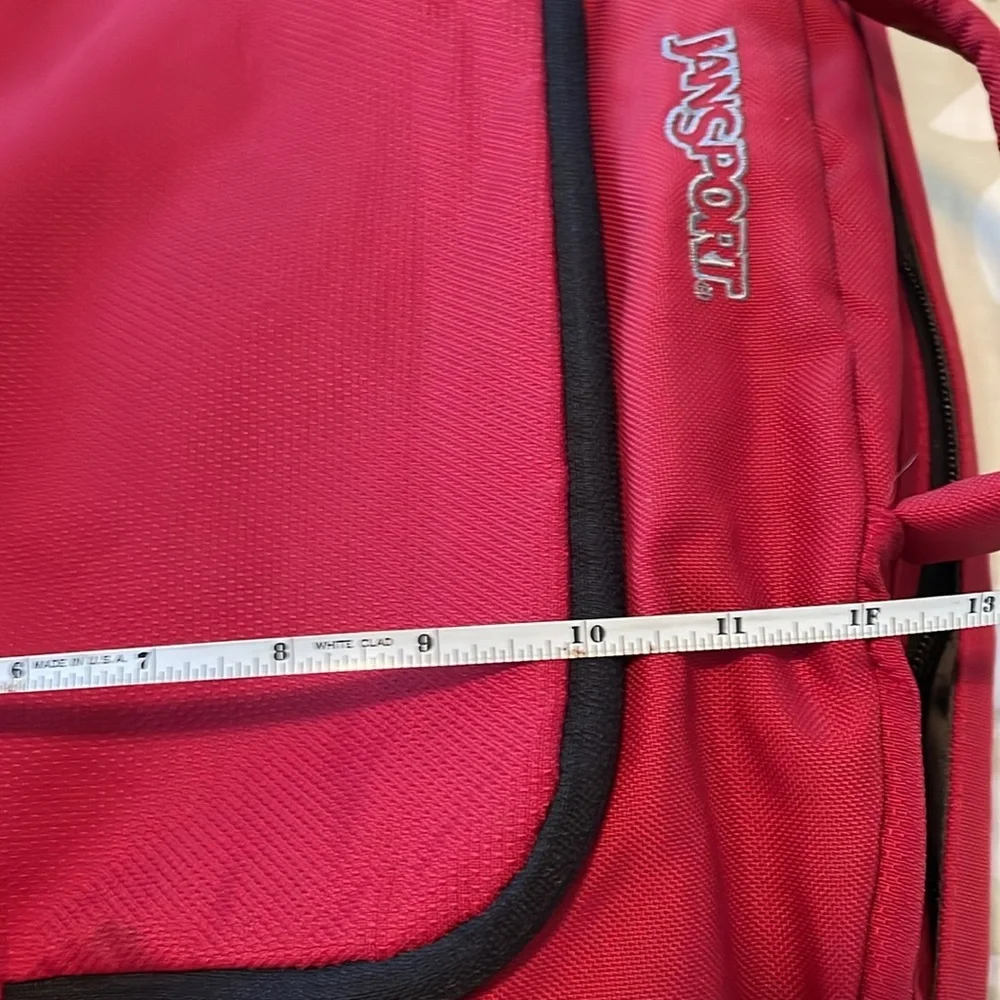 Red Jansport laptop messenger bag. Interior Velcro & outer zippered compartment